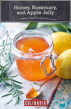 honey rosemary and apple jelly recipe in a jar with lemons on the table next to it