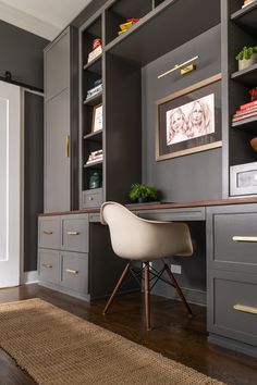 a desk and chair in a room with built - in bookshelves on the wall