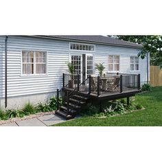 a white house with black railings and steps leading up to the front door area