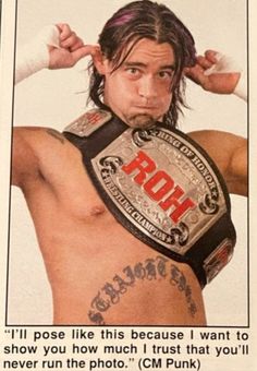 an image of a man with tattoos on his chest and arms, wearing a wrestling belt