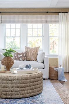 a living room filled with furniture and a large rug on top of a hard wood floor