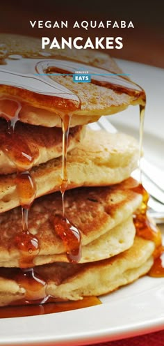 pancakes are stacked on top of each other with syrup drizzled over them