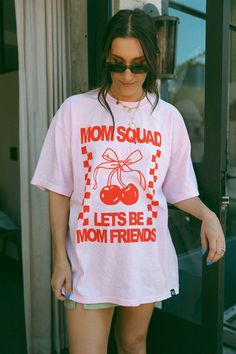 Mom Squad Lets Be Mom Friends oversized pink tee with red featuring cherry & bow graphics. Back print says Lets Be Mom Friends. Karrie is wearing a size 2XL. Features 6.1 oz./yd² (US), 10 oz/L yd (CA), 100% ring-spun cotton, 30 singles Garment dyed for that lived in feel and almost no shrinkage at home. Soft ring-spun cotton fabric with 100% cotton threads Relaxed fit Topstitched, classic width, rib collar Shoulder to shoulder twill tape Mom Tshirt Ideas Design, Trendy Tshirt Designs, Pink Tshirt Outfit, Baggy Tshirts, Mom Aesthetic Outfit, Fabric Outfits, Mothers Day Design, Mom Trends, Fun Mom