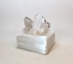 Selenite is the stone of mental clarity and love. Giant Quartz points are added to enhance and redirect the energy in all directions. We are inspired to bring these angelic qualities into your home with this elegant decorative design. Dimensions: 7" x 7" x 7" Selenite is closely related to the other crystalline forms of Gypsum: Satin Spar, a compact fibrous variety that is generally translucent with a pearly chatoyant appearance; Desert Rose, most often bladed in the familiar shape of a rose wit Sacred Space Altar, Crystal Top, Beach Bungalow, Crystal Box, Room Stuff, Diy Crystals, Meditation Room, Crystal Lamp, Treasure Box