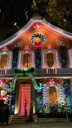 an elaborately decorated house is lit up at night with holiday decorations on the front and sides