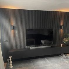 a flat screen tv sitting on top of a wooden entertainment center in a living room