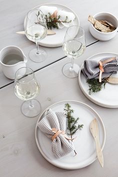 the table is set with dishes and place settings