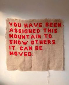 a piece of cloth with red writing on it that says you have been assigned this mountain to show others it can be moved