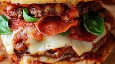 a close up of a very tasty looking sandwich with meat and cheese on it