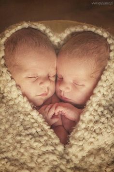 two babies are cuddling together in a heart - shaped blanket that says, good night