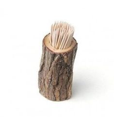 a close up of a wooden object with tooth brushes in it's holder on a white background