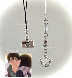 two different necklaces with charms attached to them, one has a camera and the other is