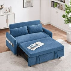 a blue couch sitting on top of a white rug