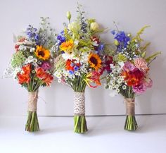 three vases filled with different types of flowers