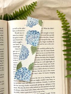 an open book with blue flowers on it