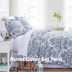 a bed with blue and white bedspreads in a room