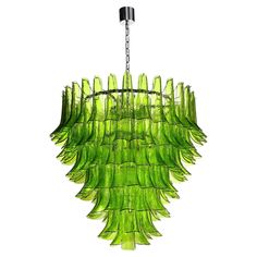 a green chandelier hanging from a chain