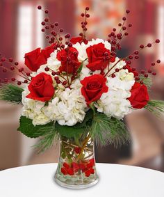 a vase filled with white and red flowers