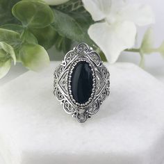 925 Sterling Silver Genuine Natural Black Onyx Gemstone Handmade Artisan Crafted Filigree Statement Ring  Material: 925 Solid Sterling Silver, 925 Stamped Genuine Black Onyx Gemstone Dimensions: 14 mm x 7 mm, Oval, Cabochon, Approximate Total Carat Weight: 2.7 Ring Face Length: 1.10 inches   Ring Face width: 0.45 inches  Finishing: Oxidized & Polished This will come in a designer pouch & gift box  Free Domestic Shipping Our fine silver jewelry is made in our exclusive artisan workshops in Turkey Sapphire Heart Ring, Emerald Gold Ring, Onyx Silver Ring, Art Deco Band, Rope Ring, Green Snake, 7 Ring, Chunky Ring, Fine Silver Jewelry