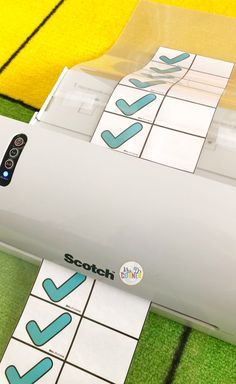 a close up of a printer on the ground with some stickers attached to it