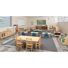 an empty classroom with tables and chairs