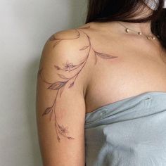 a woman with a tattoo on her shoulder