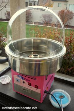 a pink and silver machine sitting on top of a table