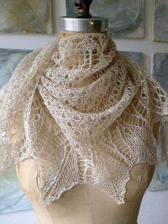 a mannequin wearing a white lacy shawl