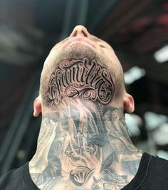 a man with tattoos on his head and neck