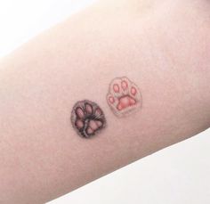 a small paw and heart tattoo on the right arm, which is also in color