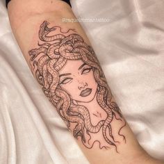 a woman's face with snakes on her arm