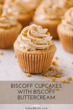 several cupcakes with frosting and sprinkles on a white surface