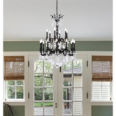 a chandelier hanging from the ceiling in a dining room