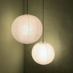 two white paper lanterns hanging from the ceiling