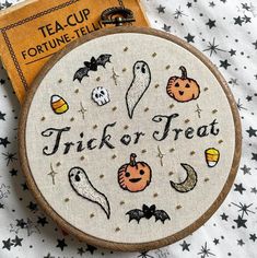 a trick or treat cross stitch pattern on a wooden hoop