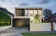 a modern house is lit up at night