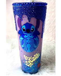 a blue and purple starbucks cup with an image of stitching on it