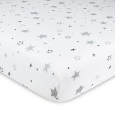 a white bed sheet with silver stars on the top and bottom, in front of a white background