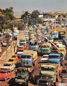 many old cars are parked on the side of the road