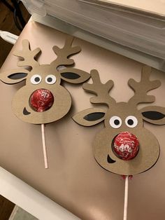 two reindeer shaped lollipops on top of a table