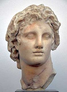 a statue of a man's head with his eyes closed and hair curled back