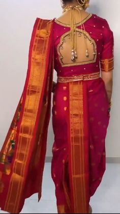 a woman in a red and gold sari