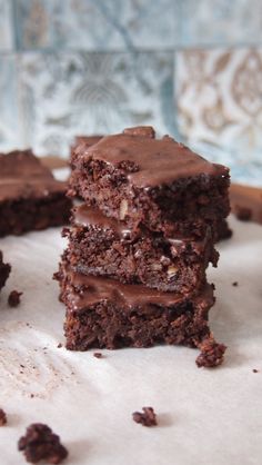 three pieces of chocolate cake sitting on top of a table