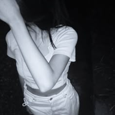 black and white photograph of a woman holding her hand up to her face with both hands