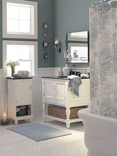 a bathroom with blue walls and white fixtures