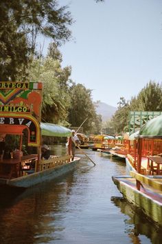 there are many boats on the water and one is painted red, green, yellow and blue