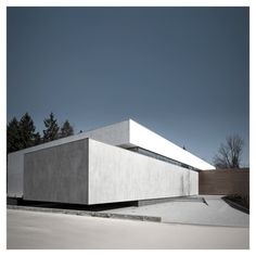 a white building sitting on top of a parking lot