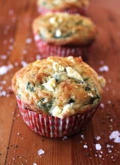 three muffins sitting on top of a wooden table