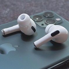 an iphone with ear buds sitting on top of it next to the boxpods logo