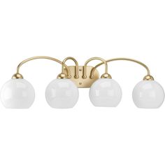 three light bathroom fixture in an antique brass finish with white glass balls on the arms